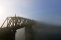 The railway bridge over the river in the fog. Royalty Free Stock Photo