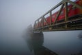 Railway Bridge With Red Train In The Fog Royalty Free Stock Photo