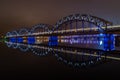 The Railway Bridge in Riga at night with train crossing the bridge Royalty Free Stock Photo