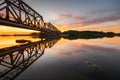 Railway bridge of steel construction in the light of the setting sun Royalty Free Stock Photo