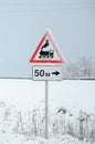 Railway crossing without barrier. A road sign depicting an old black locomotive, located in a red triangle Royalty Free Stock Photo