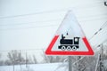 Railway crossing without barrier. A road sign depicting an old black locomotive, located in a red triangle Royalty Free Stock Photo