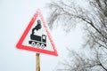 Railway crossing without barrier. A road sign depicting an old black locomotive, located in a red triangle Royalty Free Stock Photo