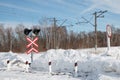 Railway crossing road sign and traffic light on a winter day Royalty Free Stock Photo