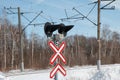 Railway crossing road sign and traffic light on a winter day Royalty Free Stock Photo