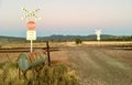 Railway crossing sign with Australian landscape.