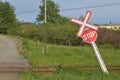 Leaning stop sign and railroad crossing in rural Nova Scotia Royalty Free Stock Photo