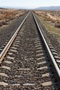 Railway in the desert converging to the horizon Royalty Free Stock Photo