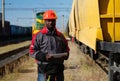 Railway employee holds in hands tablet pc and look at camera