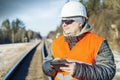 Railway employee with tablet PC near the railway