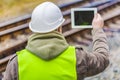 Railway engineer filmed rails with tablet PC Royalty Free Stock Photo