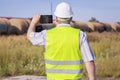 Railway Engineer filmed with tablet PC near freight wagons Royalty Free Stock Photo