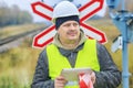 Railway engineer with tablet PC near warning signs Royalty Free Stock Photo