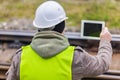 Railway engineer with tablet PC on rails Royalty Free Stock Photo