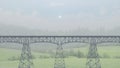 railway iron bridge side view on three supports Royalty Free Stock Photo