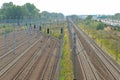 A railway junction featuring multiple sets of tracks, signals, and overhead power lines