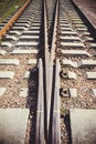 Railway junction tracks in the city with track bed. Gravel and switch at a railroad crossing Royalty Free Stock Photo