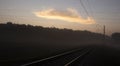 Railway leaving for the horizon in the autumn forest in the morning mist Royalty Free Stock Photo