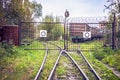 The railway line abuts against closed lattice metal gates, behind which the rails diverge in two different directions