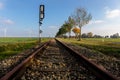 A railway line leads straight to the horizon in the flat landscape. Royalty Free Stock Photo