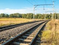 Electric railway lines going through a rural landscape