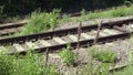 Railway on metal rails of jointed track on concrete sleepers upon crushed stone track ballast. another track on wood sleepers in