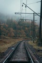 Railway in the mountains. Railroad tracks in autumn mountains. Railroad in foggy morning landscape. Transportation industry Royalty Free Stock Photo