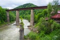 Railway and an old suspension bridge across mountain river Royalty Free Stock Photo