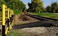 railway pedestrian crossing with yellow and black striped steel tube railing