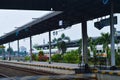 Railway Platform at Cirebon Prujakan Station with Intercity Train and Directional Signage Royalty Free Stock Photo