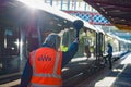 Railway platform guard waves an all clear signal to a train conductor. Royalty Free Stock Photo