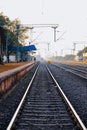 railway platform or station with track, cable line goes above the rail line to pass electricity, Metal railway track in india, Royalty Free Stock Photo