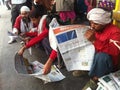 Railway porters sitting down and reading the newspapers early in the morning