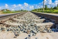 Railway rails in rural areas. Beautiful sky with clouds. Siberian urban landscape