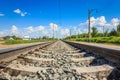 Railway rails in rural areas. Beautiful sky with clouds. Siberian urban landscape