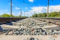 Railway rails in rural areas, passing through the forest. Beautiful sky with clouds. Siberian urban landscape