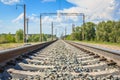 Railway rails in rural areas, passing through the forest. Beautiful sky with clouds. Siberian urban landscape