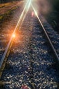 Setting sun and reflection on rails Royalty Free Stock Photo