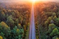 The railway runs through the forest. Empty tracks at sunset or dawn. Royalty Free Stock Photo