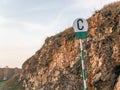 Railway signal sign C about blowing a whistle on a background of rail and rock Royalty Free Stock Photo