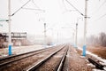 Railway in snowfall with the fog. Winter railway transportation Royalty Free Stock Photo