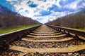 Railway station against a beautiful colorful sky at sunset. Industrial landscape with railroad, blue sky with clouds in summer. Royalty Free Stock Photo