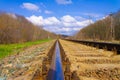 Railway station against a beautiful colorful sky at sunset. Industrial landscape with railroad, blue sky with clouds in summer. Royalty Free Stock Photo