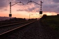 Railway station against beautiful sky at sunset. Industrial landscape with railroad, colorful blue sky with red clouds, sun Royalty Free Stock Photo