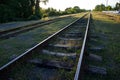 Railway station against beautiful sky at sunset. Industrial landscape with railroad, colorful sky with clouds, sun, trees and Royalty Free Stock Photo