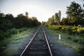 Railway station against beautiful sky at sunset. Industrial landscape with railroad, colorful sky with clouds, sun, trees and Royalty Free Stock Photo