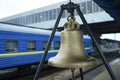 Railway station bell set on platform of the Grand Central train station, blurred wagon of a passenger train on a background