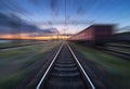 Railway station with cargo wagons in motion blur effect at sunse Royalty Free Stock Photo