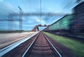 Railway station with cargo wagons in motion blur effect at sunse Royalty Free Stock Photo