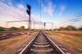 Railway station at colorful sunset with motion blur effect. Rail Royalty Free Stock Photo